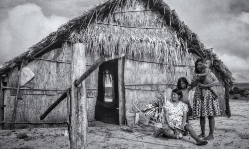Akawaio family in front of tree bark home at Maiurupai outpost