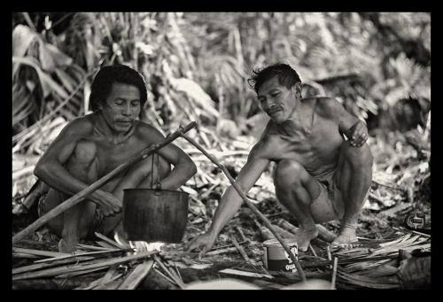 Akawaio men kindle a fire under hanging pot at Camp 6
